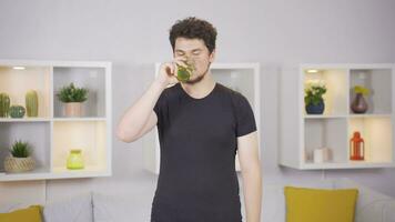 Man doing sports exercises at home drinking water. video