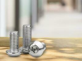 Stainless Button Head Screws isolated on table with room background photo