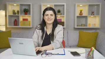 Home office worker woman waving at camera. video