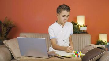 Boy studying on laptop. video
