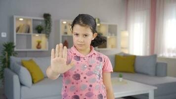 Girl child making stop sign for camera. video