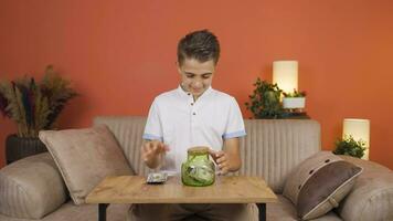 Positive boy saving money in piggy bank. video