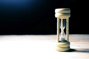 hourglass on the table with wasted time. photo