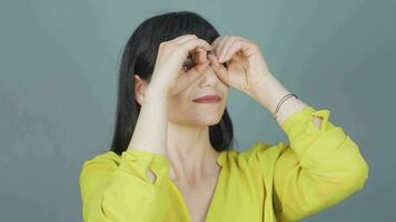 Woman with binoculars looking away. video