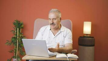 Man making video call on laptop.