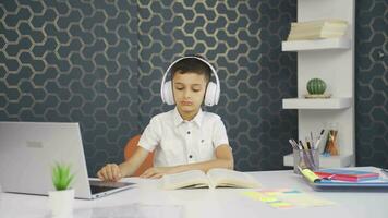 Boy listening to music with headphones at home video