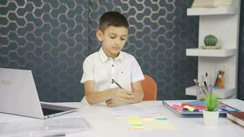 The boy is studying at home, solving questions. video