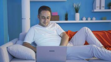 Man using laptop while lying down. video