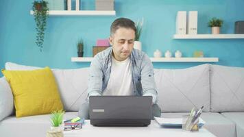 Man working on laptop throws files angrily. video