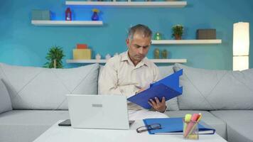 Home office worker man taking notes, jotting down information. video