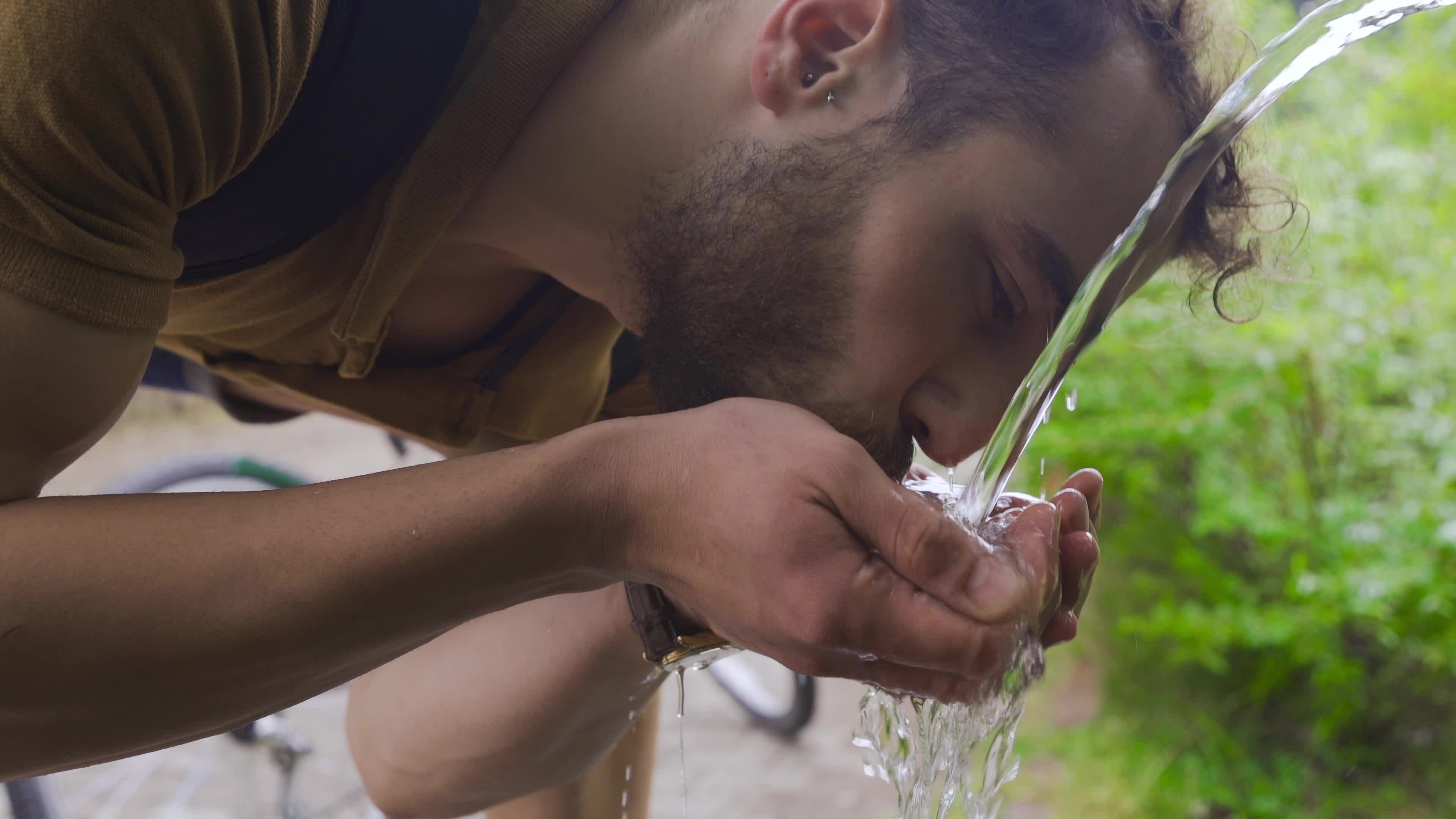 Water quality expert testing natural spring water in forest setting