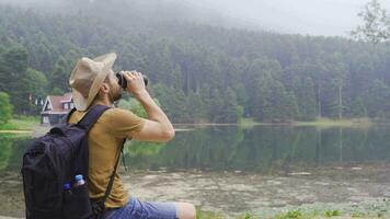 Free man is resting on the lake shore. video