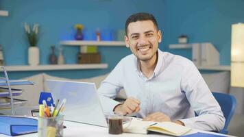 Home office worker man looking at camera with excitement and feeling happy. video