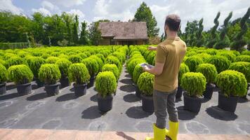 Modern gardener working with his tablet in greenhouse. video