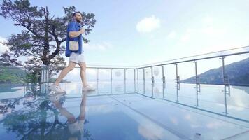 Man walking on glass terrace. video