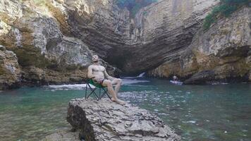 Lonely young man camping at sea. video