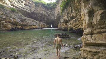 Sea cave surrounded by bales of rock. video