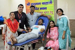 Delhi, India, June 19 2023 - Blood donor at Blood donation camp held at Balaji Temple, Vivek Vihar, Delhi, India, Image for World blood donor day on June 14 every year, Blood Donation Camp at Temple photo