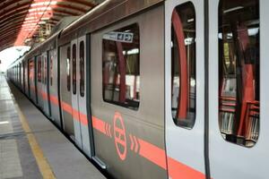 New Delhi India - August 10 2023 - Delhi Metro train arriving at Jhandewalan metro station in New Delhi, India, Asia, Public Metro departing from Jhandewalan station photo