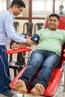 Delhi, India, July 19 2023 - Blood donor at Blood donation camp held at Balaji Temple, Vivek Vihar, Delhi, India, Image for World blood donor day on June 14 every year, Blood Donation Camp at Temple photo