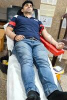 Delhi, India, June 19 2023 - Blood donor at Blood donation camp held at Balaji Temple, Vivek Vihar, Delhi, India, Image for World blood donor day on June 14 every year, Blood Donation Camp at Temple photo