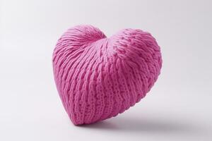 Pink knitted heart on a white background. Valentine's Day.AI Generated photo