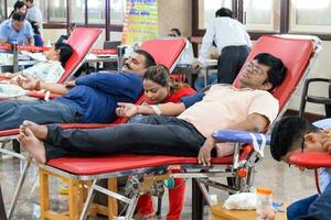 Delhi, India, June 19 2023 - Blood donor at Blood donation camp held at Balaji Temple, Vivek Vihar, Delhi, India, Image for World blood donor day on June 14 every year, Blood Donation Camp at Temple photo