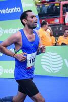 New Delhi, India - July 16 2023 - Vedanta Delhi Half Marathon race after covid in which marathon participants about to cross the finish line, Delhi Half Marathon 2022 photo