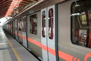 New Delhi India - August 10 2023 - Delhi Metro train arriving at Jhandewalan metro station in New Delhi, India, Asia, Public Metro departing from Jhandewalan station photo