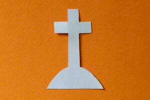 cross on a grave paper cut in halloween theme photo