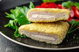 cordon bleu fresh cutlet chicken meat, cheese, bacon appetizer meal food snack on the table photo