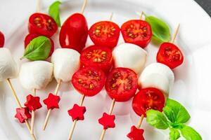 tomato and mozzarella salad on a skewer Caprese finger food appetizer eating cooking appetizer meal food snack on the table photo