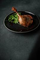 duck leg confit berry sauce poultry meat eating cooking appetizer meal food snack on the table photo