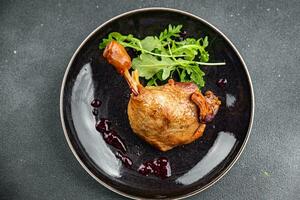 duck leg confit berry sauce poultry meat eating cooking appetizer meal food snack on the table photo