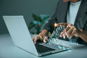 The analyst works on a laptop showing data business analysis and Data Management System with KPI for financial report and data analysis, business target and development. photo