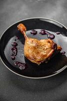 duck leg confit berry sauce poultry meat eating cooking appetizer meal food snack on the table photo