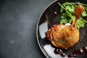 duck leg confit berry sauce poultry meat eating cooking appetizer meal food snack on the table photo