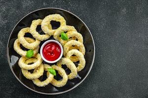 onion rings in batter deep fryer tomato sauce fast food delicious eating cooking appetizer meal food snack on the table copy space photo