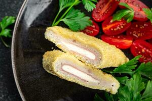 cordon bleu fresh cutlet chicken meat, cheese, bacon appetizer meal food snack on the table photo