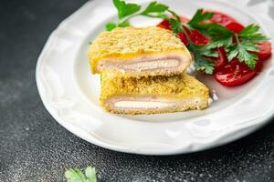 cordon bleu fresh cutlet chicken meat, cheese, bacon appetizer meal food snack on the table photo