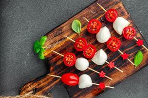 tomato and mozzarella salad on a skewer Caprese finger food appetizer eating cooking appetizer meal food snack on the table photo