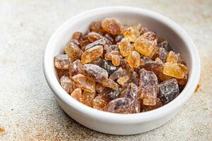 rock sugar crystals pieces candy brown sugar candied big rock caramel taste cane sugar healthy eating cooking appetizer meal food snack on the table photo