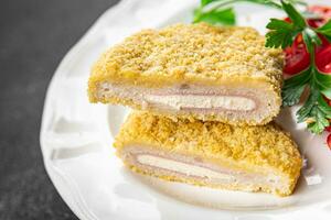 cordon bleu fresh cutlet chicken meat, cheese, bacon appetizer meal food snack on the table photo