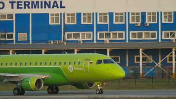 NOVOSIBIRSK, RUSSIAN FEDERATION JUNE 17, 2020 Civil plane Embraer E170, VQ BYH of S7 Airlines taxiing at Tolmachevo Airport, Novosibirsk. Airplane on the taxiway. Tourism and travel concept video