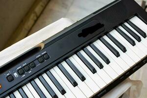 Close-up of piano keys. Piano black and white keys and Piano keyboard musical instrument placed at the home balcony during sunny day. photo