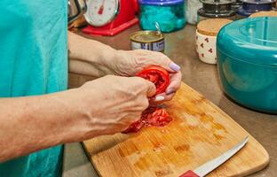 Chef is preparing tomatoes for stuffing. French gourmet food photo