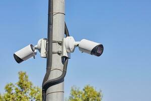 Security cameras are installed in the park on an electricity pole photo