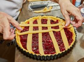 Chef makes cherry pie in his home kitchen photo