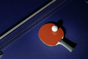 table tennis racket On the blue ping pong table photo