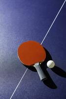 table tennis racket On the blue ping pong table photo